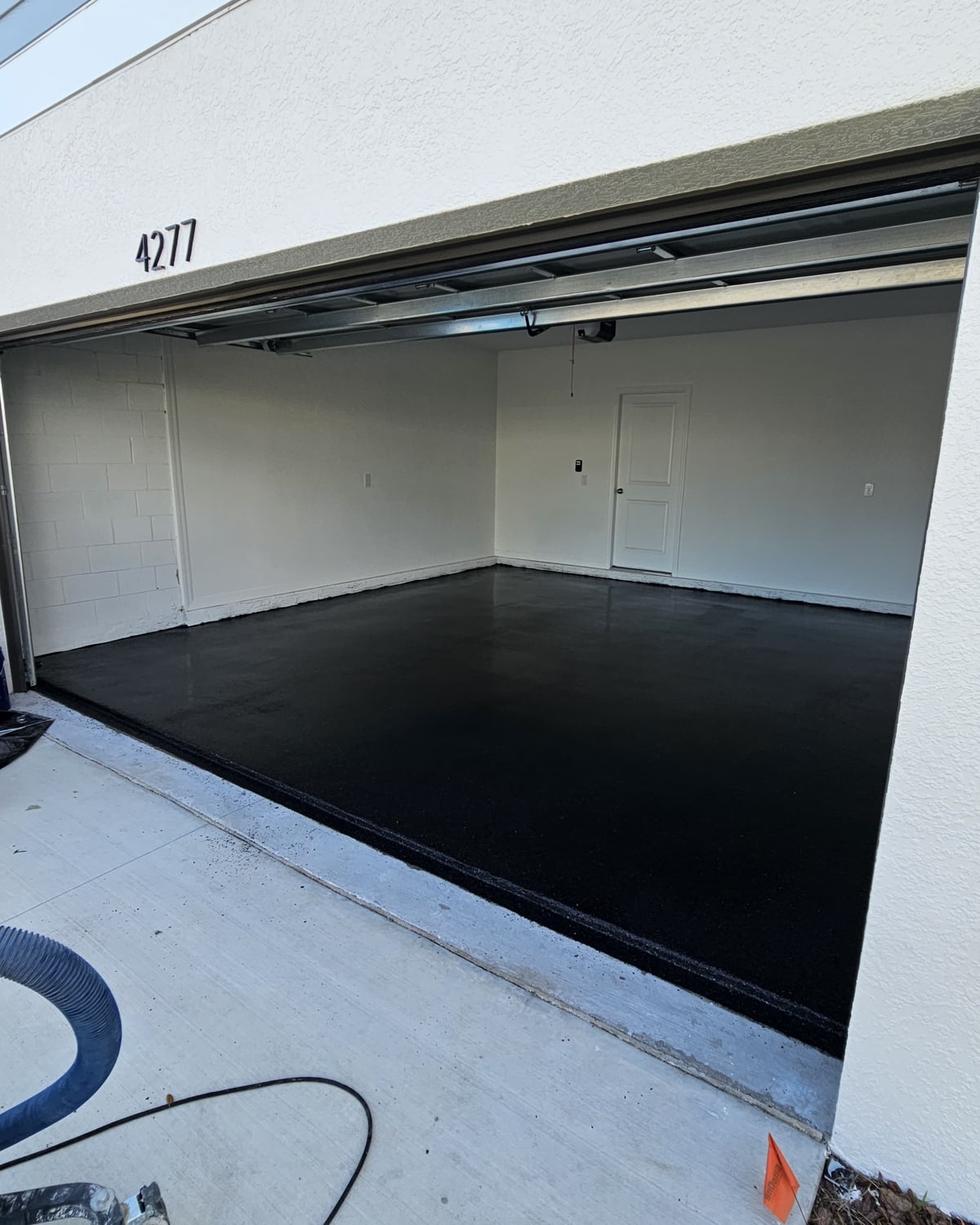 Freshly poured epoxy garage floor on a Veridian Vantage job in Central Florida