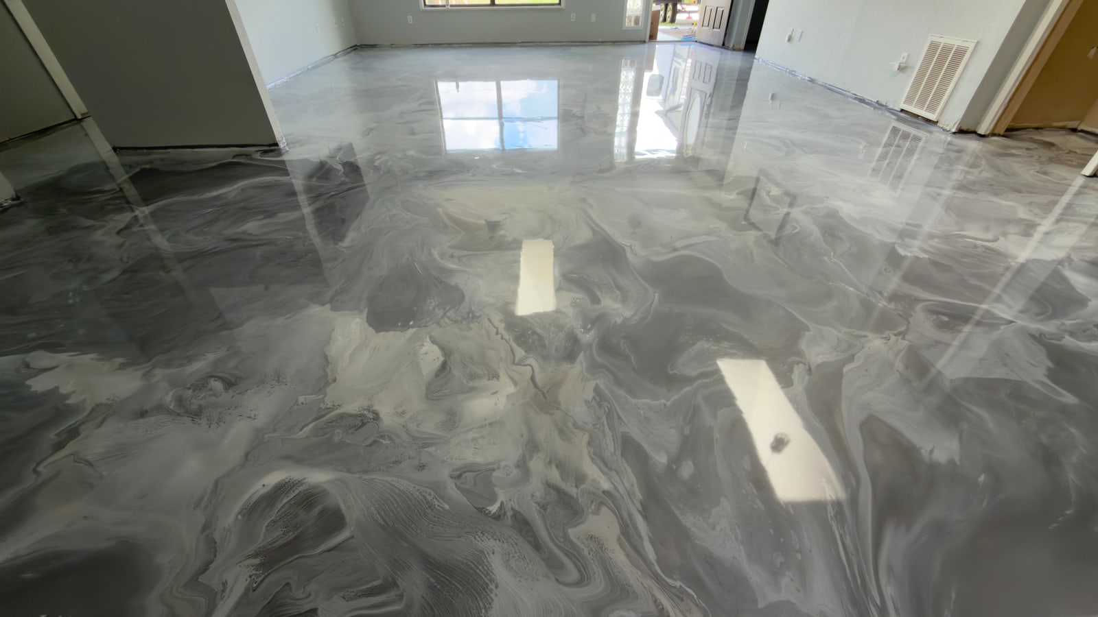 Completed metallic epoxy floor across an open-plan interior